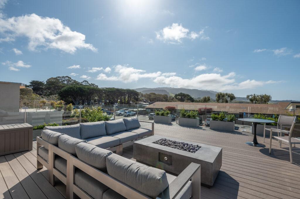 Ground-level view of remodeled Carmel home patio with putting green and sliding glass doors to interior
